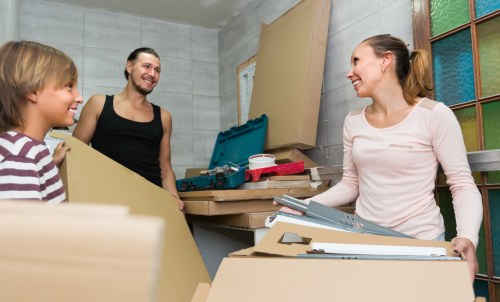 Specialist piano removals team preparing an upright piano in a Tufnell Park home