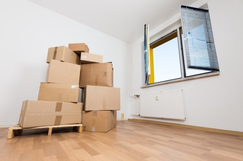 Packed moving boxes and furniture ready for transport in a London property
