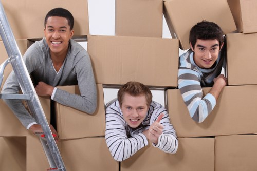 Professional movers navigating narrow stairs and hallways in a Tufnell Park flat