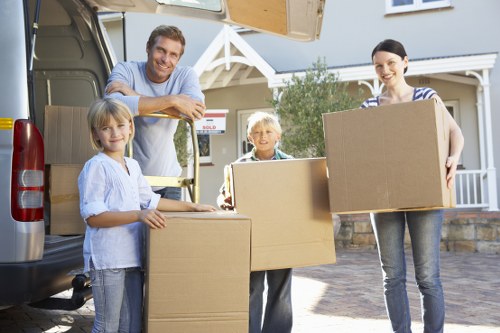 Packed boxes and furniture ready for collection by a removal van