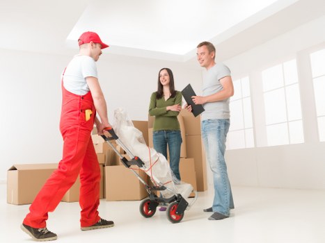 Family home move preparation with labelled boxes and furniture protection