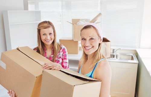 Local movers carrying items from a Tufnell Park apartment